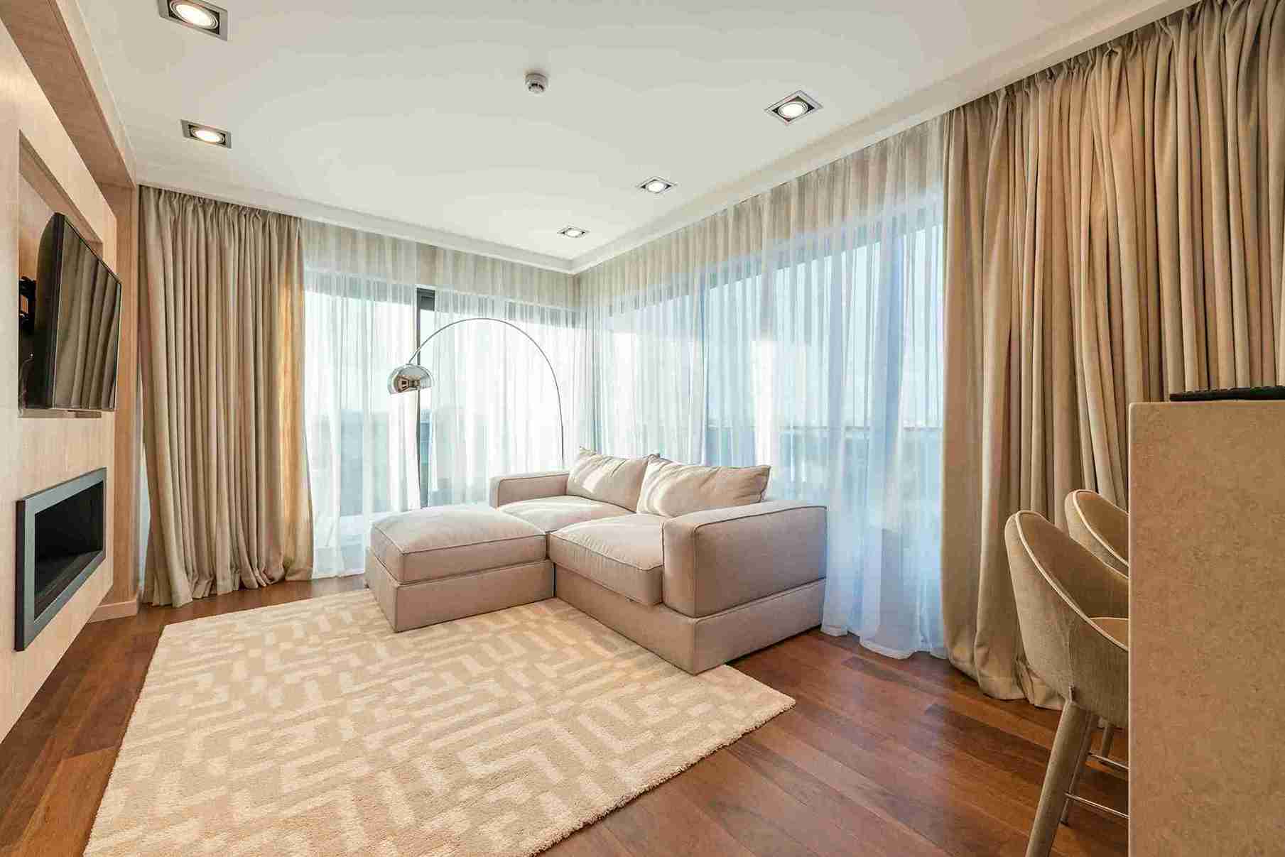 Floor-to-ceiling dark brown drapes covering an entire wall in a luxury interior — Veloura Drapery