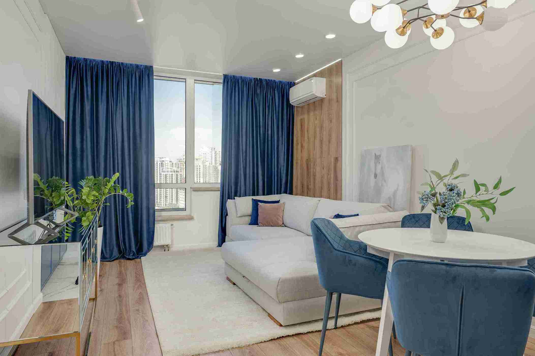 Layered sheer and brown drapes in a grand luxury villa living room — Veloura Drapery