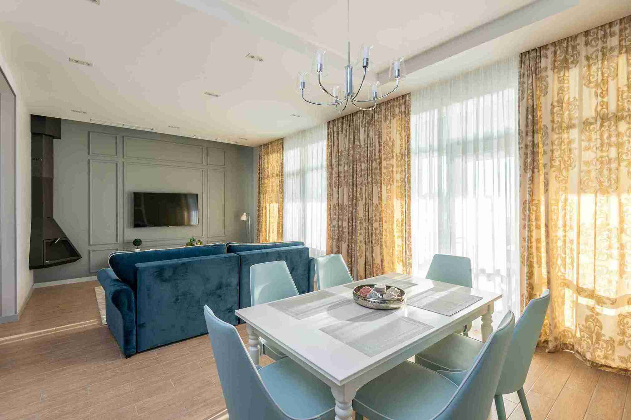 Layered premium beige sheer and drape curtains in a luxury living room — Veloura Drapery Hyderabad