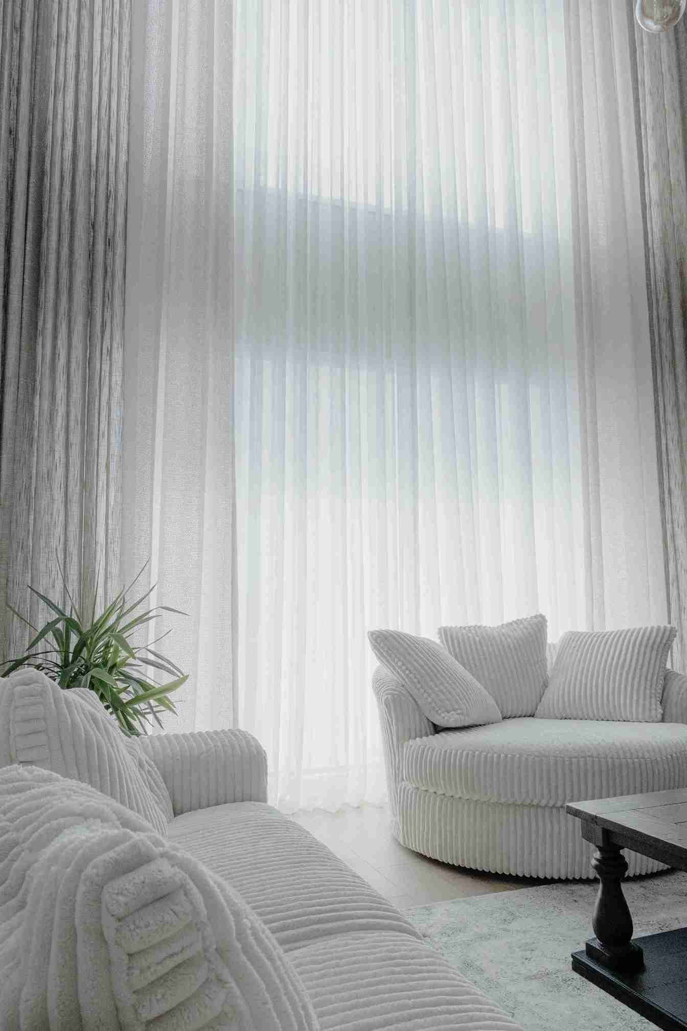 Premium sheer curtains with soft taupe drapes in an elegant bedroom — Veloura Drapery Sheer Elegance
